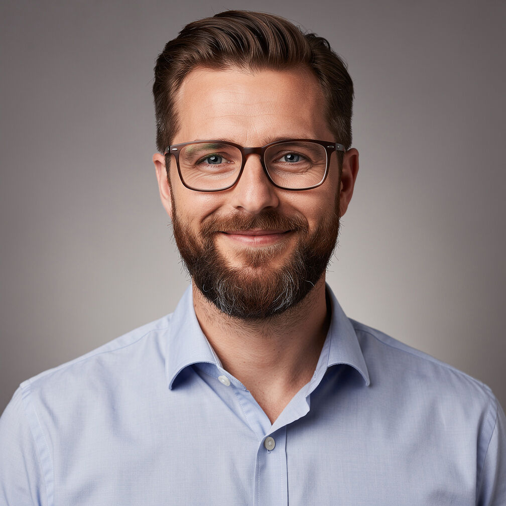 Studio portrait of a man with a beard and glasses
